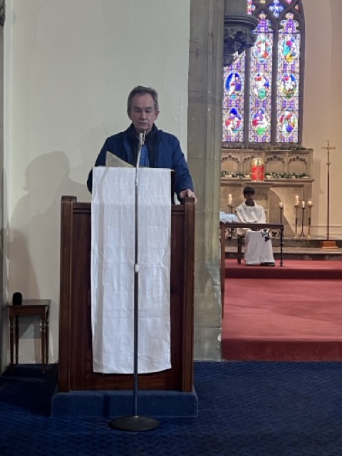 Members of the parish standing in prayer during the Family Eucharist