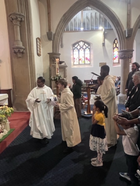 A family approaching for Communion during the Family Eucharist
